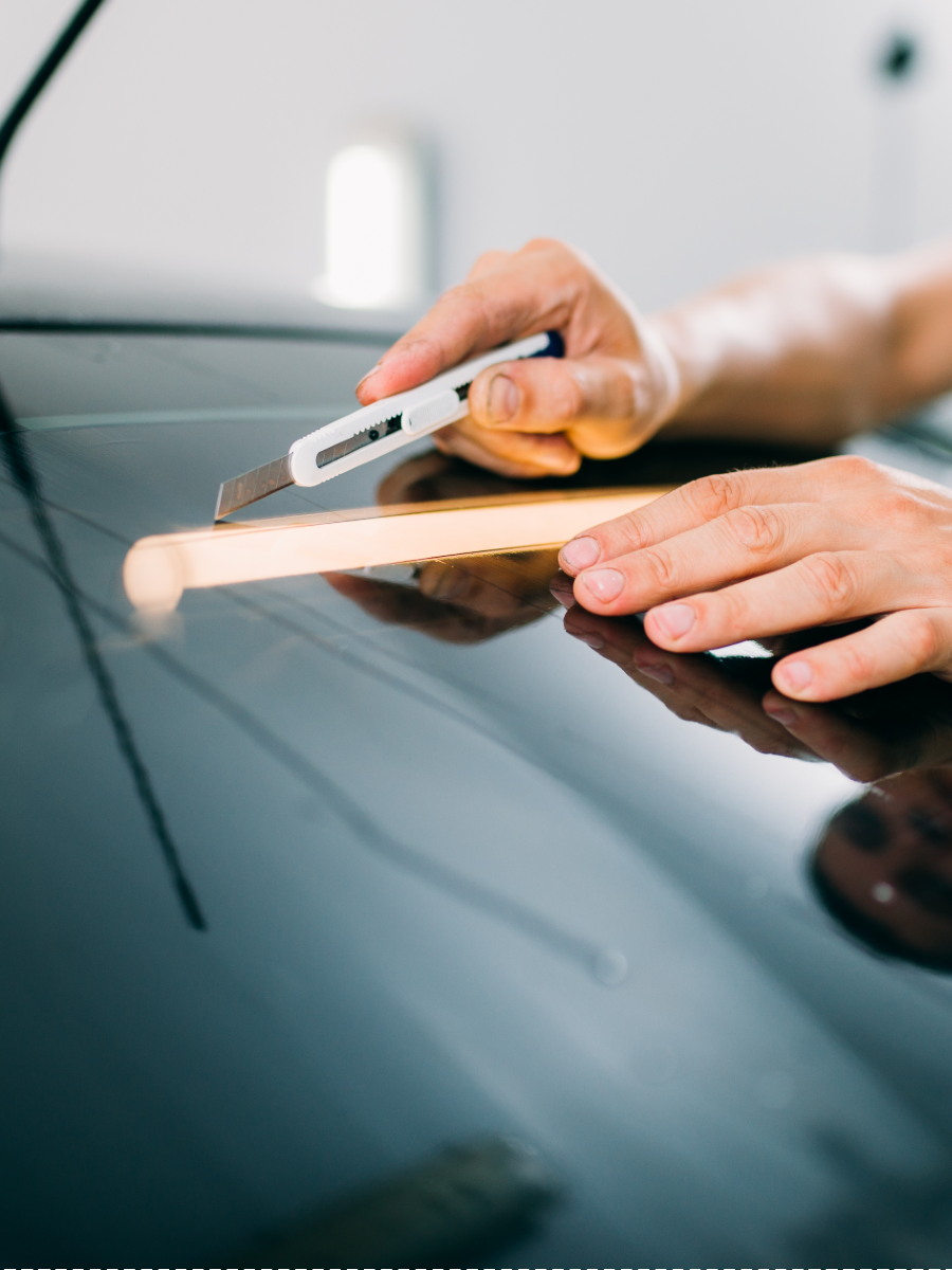 man installing auto window tint