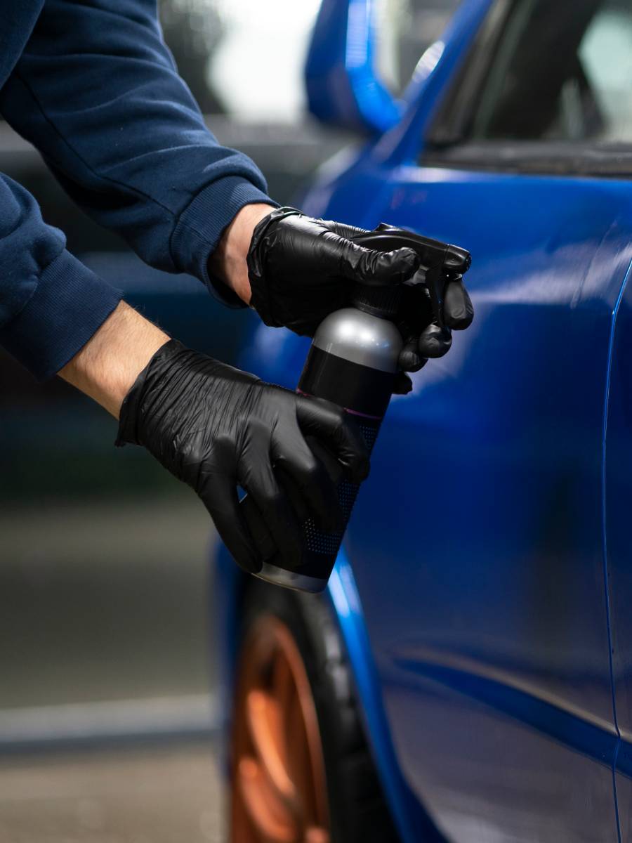 service man applying opti coat pro to blue car