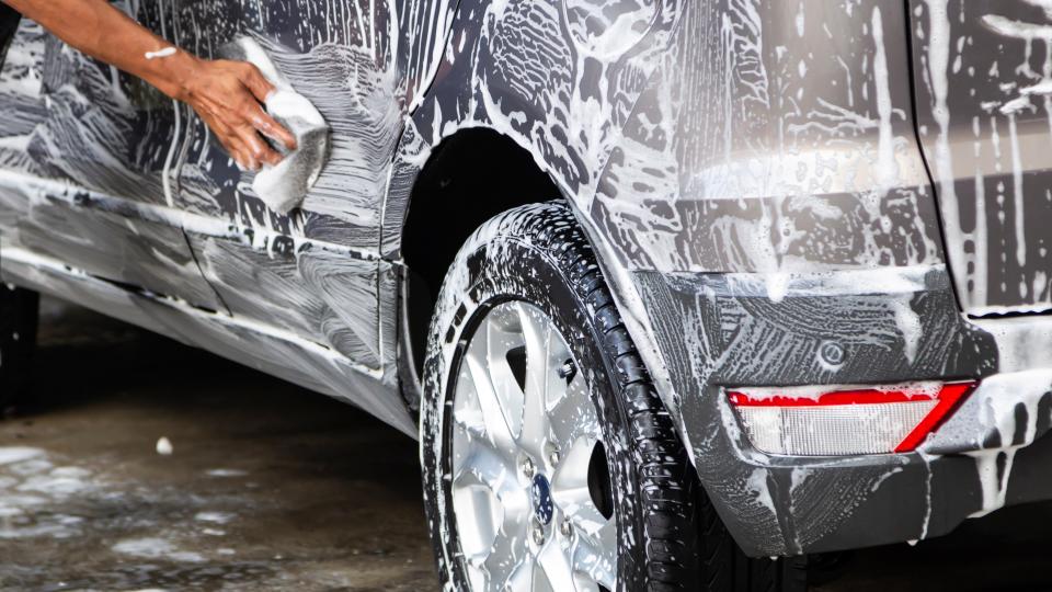 washing silver car by hand