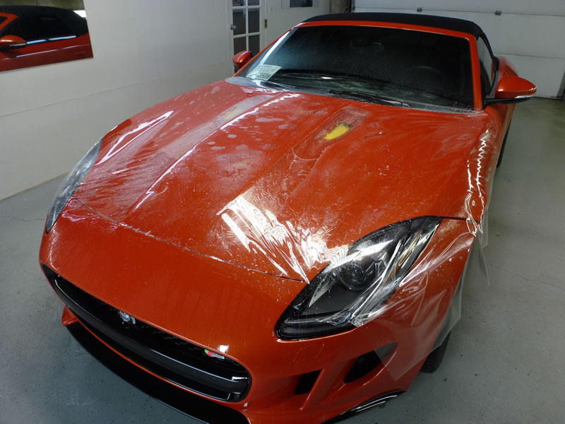 Orange Jaguar F-Type receiving clear bra