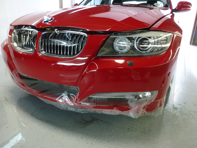 Red BMW 335i getting clear bra on front bumper