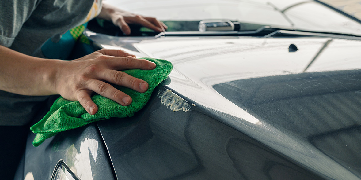 man drying car with towel