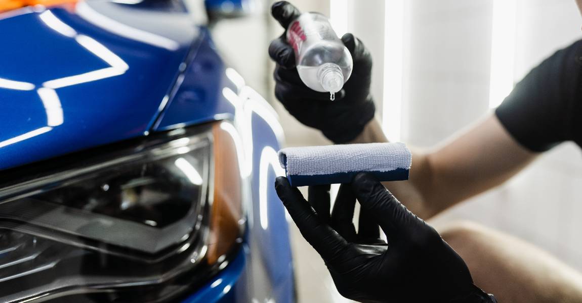 ceramic liquid coating pouring from bottle to apply to sponge