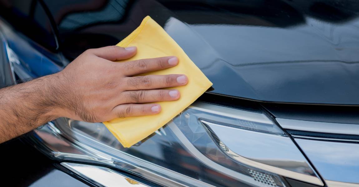 washing car with yellow microfiber towel