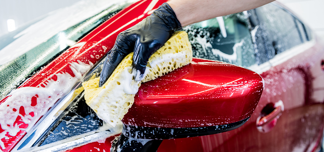 washing red car to apply ceramic coating