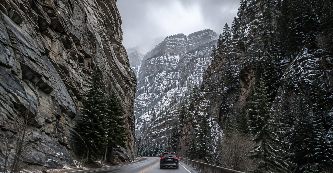 Vehicle traveling through a Colorado mountain highway canyon corridor