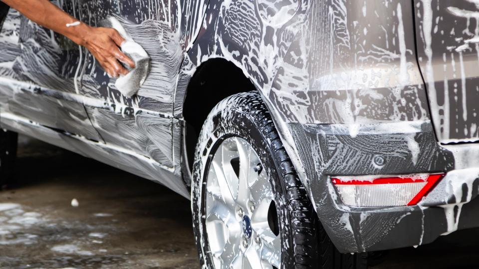 washing silver car by hand